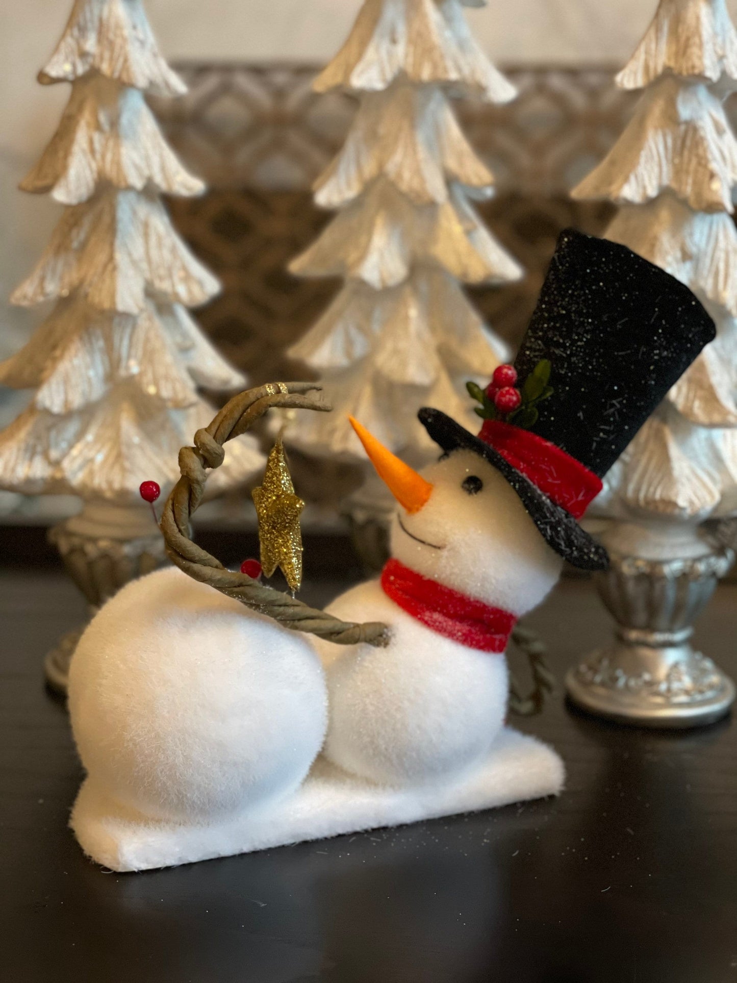 9.75” frosted snowman laying with star tabletop ornament